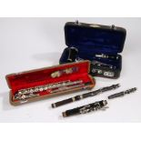 Instruments, to include a cased clarinet with associated parts, a part flute and a cased flute, (3)