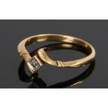 18 carat gold diamond set ring, the white metal square head with a central diamond and cross over