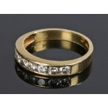 18 carat gold half eternity ring, with a row of seven round cut diamonds totalling 0.58 carat,