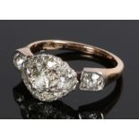 18 carat gold diamond cluster ring, the head with a central round diamond with an oval multiple