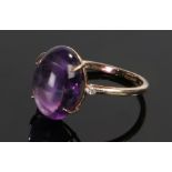 9 carat gold amethyst set ring, the cabochon amethyst flanked by a diamond chip to either side, ring