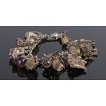 Silver charm bracelet, with various attached charms, 100 grams