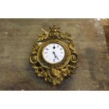 French gilt metal wall clock, with pierced foliate and scroll decorated case, the white enamel