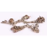 Silver charm bracelet with four charms, 27g