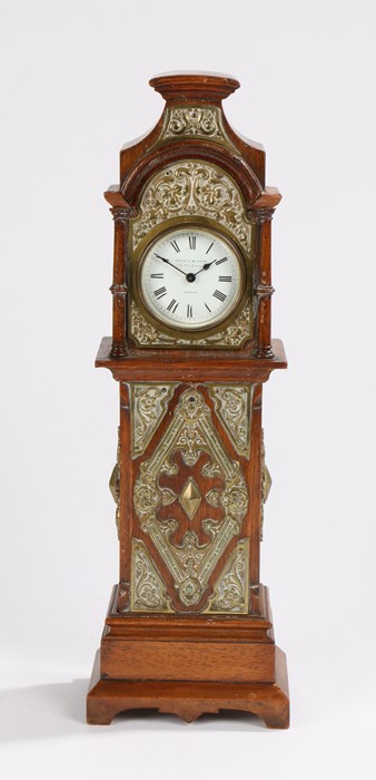 Victorian oak and brass miniature longcase clock, the arched pediment above a signed Howell &