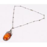 Silver mounted amber pendant, the mount with foliate decoration, on a white metal necklace formed