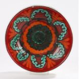 Poole Pottery delphis pattern bowl, the red ground with orange and green foliate decoration and