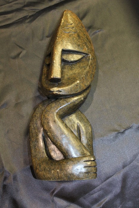 Carved abstract bust, depicting a stylised figure resting a hand under their chin, 32.5cm high