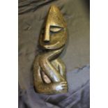 Carved abstract bust, depicting a stylised figure resting a hand under their chin, 32.5cm high