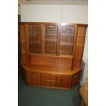 Teak display cabinet, with three glazed central drawers flanked by glass shelves, the base with
