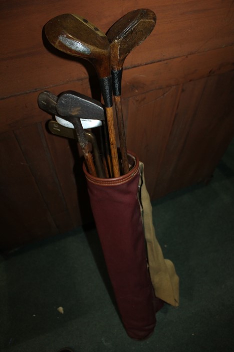 Hickory shafted golf clubs, to include four irons, putter and two woods, housed in a Cliffco leather