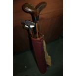 Hickory shafted golf clubs, to include four irons, putter and two woods, housed in a Cliffco leather