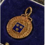 9 carat gold pocket watch pendant, with blue enamel crest to centre surrounded by raised lettering