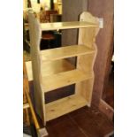 Pine open bookcase, with four shelves on shaped end supports, 43.5cm x 77.5cm