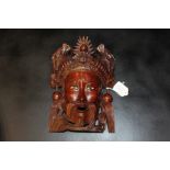 Chinese carved mask, of a man with bird and dragons to his headdress, 27cm high