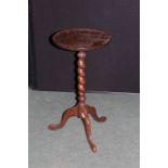 Oak wine table, the circular top raised on barley twist central column and tripod legs, 30cm