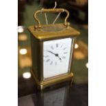 French brass carriage clock, with a white enamel dial