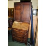 Mahogany bureau bookcase, the top with panelled cupboard doors opening to reveal three adjustable