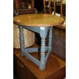 Cherry wood occasional table, the circular top raised on three blue painted turned legs and