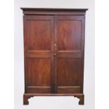 George III mahogany Channel Islands wardrobe, the cornice above a pair of panel doors on bracket