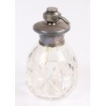 Edwardian white metal mounted perfume atomiser, with engine turned cap and clear glass lower