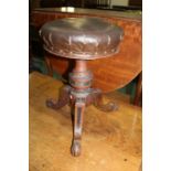 Victorian mahogany piano stool, the circular adjustable leather seat raised on a carved turned stem,