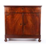 Victorian mahogany side cabinet, the frieze drawer above two cupboard doors, with ebonised shield