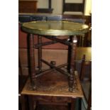 Benares brass tray on a turned folding stand, 59.5cm diameter