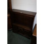 Oak bookcase, with a rectangular top above an open front and cupboards below