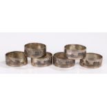 Set of six Middle Eastern white metal napkin rings with niello style landscape and riverside