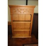 Pine wall hanging open bookshelf, with stepped pediment above a foliate basket carved panel and