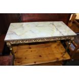 Marble effect coffee table, with gilt scroll carved frieze, raised on turned legs, 89cm x 44cm