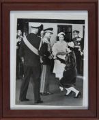 Princess Margaret Curtsies as she shakes the hand of the Shah of Iran