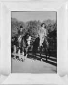 Empress Farah Diba and Crown Prince Reza ride on the grounds of the Palace at Saadabad