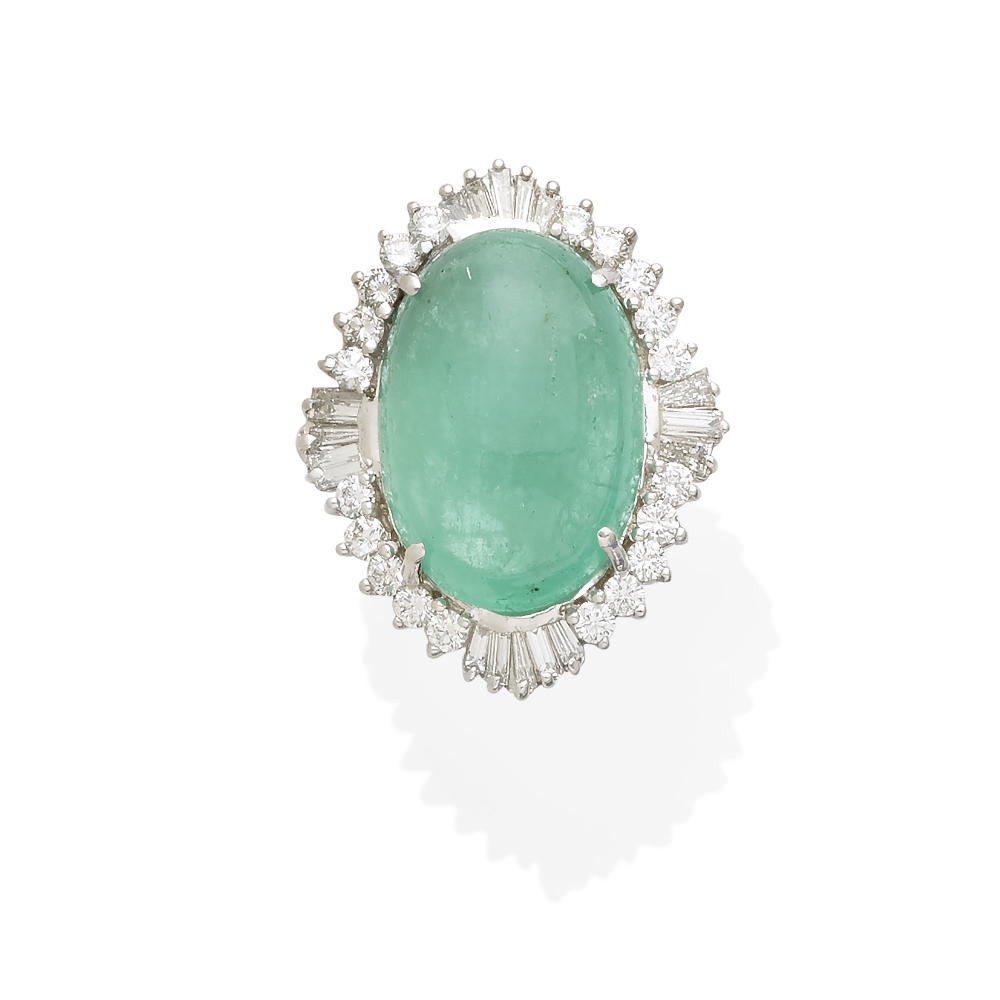 An emerald cabochon and diamond ring