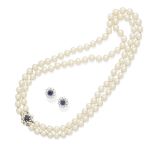 A double strand pearl necklace with a pair of sapphire and diamond earrings