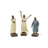A pair of Vienna cold painted bronze figures of Dervishes and a cloaked man with staff Franz Berg...