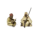 A Vienna cold painted bronze figure of a seated scribe and a seated cloaked man with rifle Franz ...