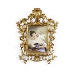 A Continental porcelain plaque in a Florentine style giltwood frame Late 19th/early 20th century