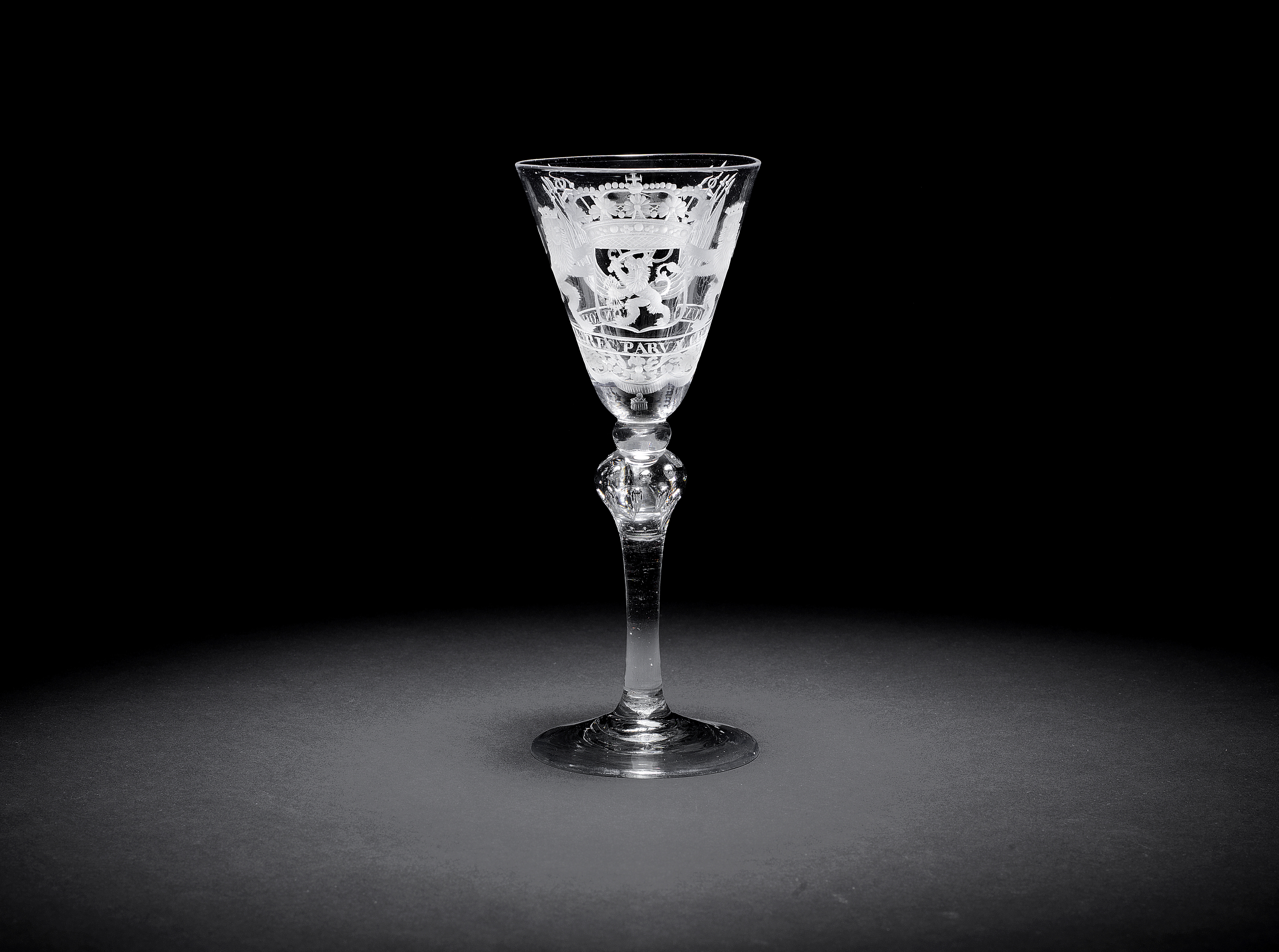 A rare Dutch engraved armorial 'VOC' light baluster wine glass, circa 1750