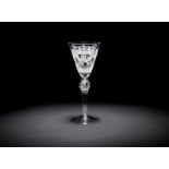 A rare Dutch engraved armorial 'VOC' light baluster wine glass, circa 1750