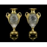 A pair of early 19th century Russian gilt bronze and cut glass vases in the Empire taste after de...
