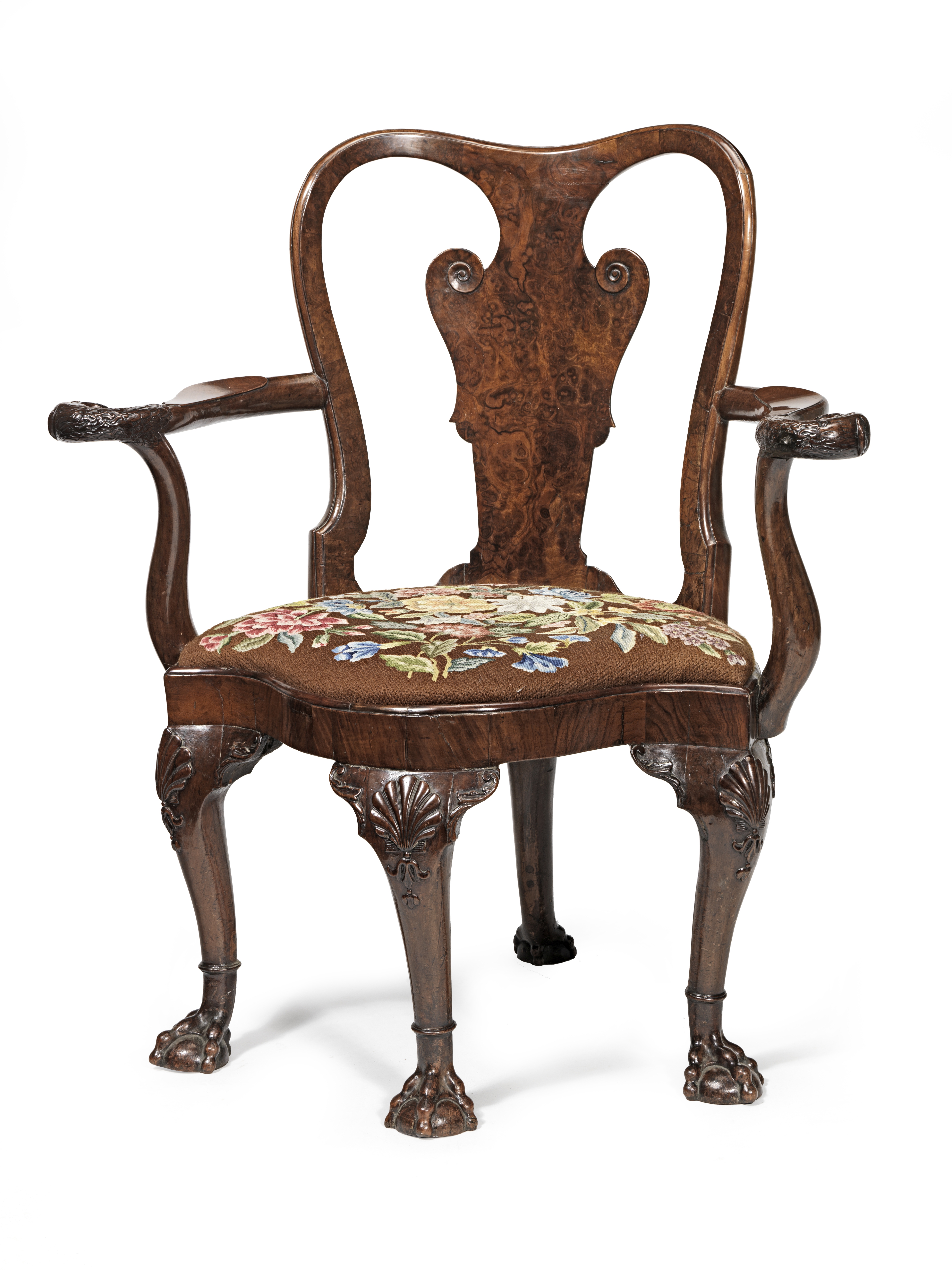 A George I carved and figured walnut corner or 'writing' armchair in the manner of William Hallett