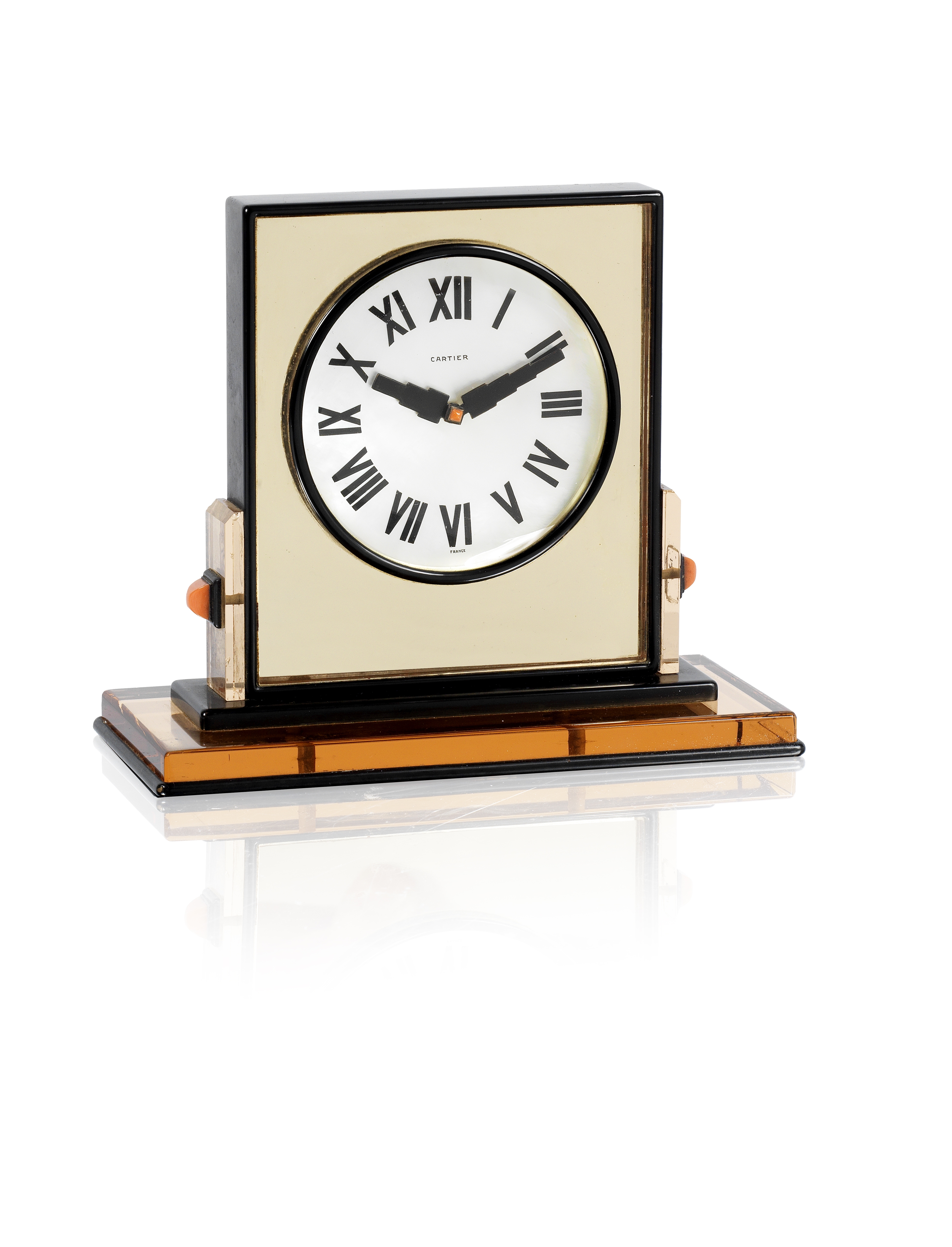 an art deco mother-of-pearl, gilt metal, enamel and corallium rubrum mirrored desk clock by Cartier,