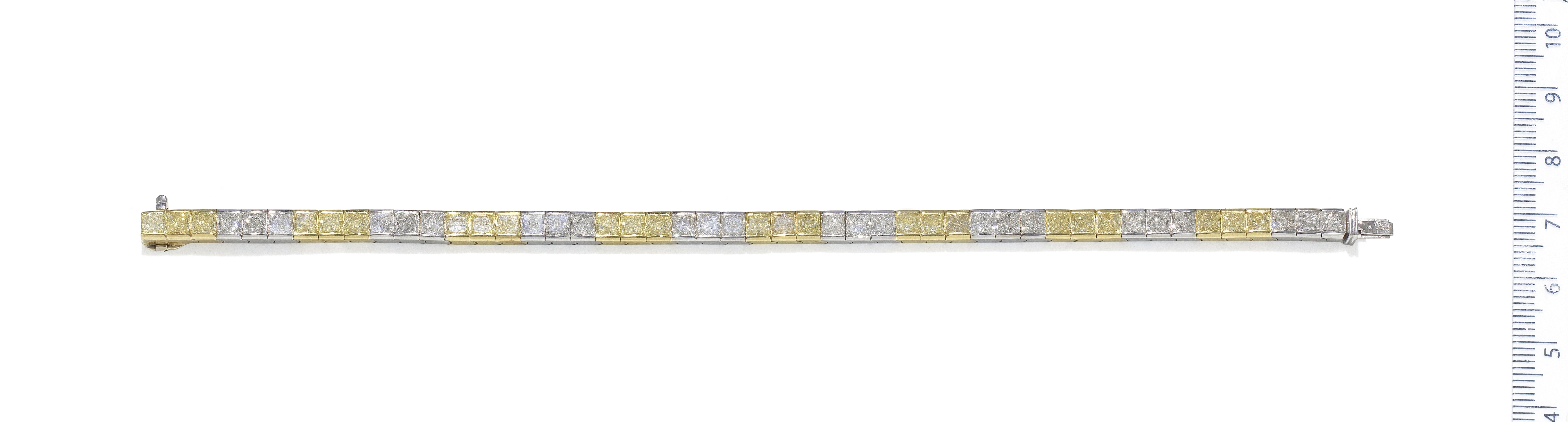 A fancy-coloured diamond and diamond line bracelet