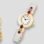 Cartier. A fine lady's 18K gold, carved ruby and diamond set quartz bracelet watch Colisèe Tutti...