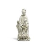 A Dehua porcelain figure of a seated Guanyin with child 19th century