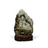 A GREEN AND BROWN JADE GUANYIN GROTTO