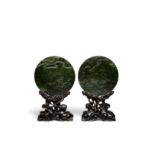 A pair of circular spinach jade plaques (4)