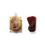 A mounted carved jade pendant and a small amber carving (2)